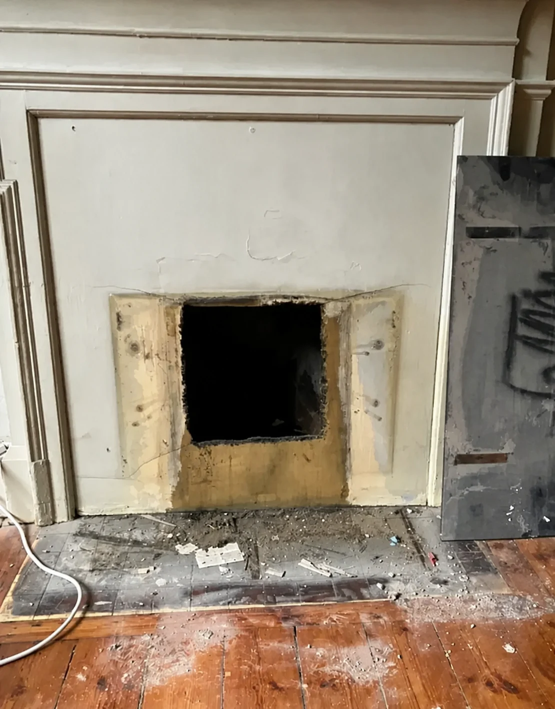 Asbestos insulating board removed from a fireplace opening