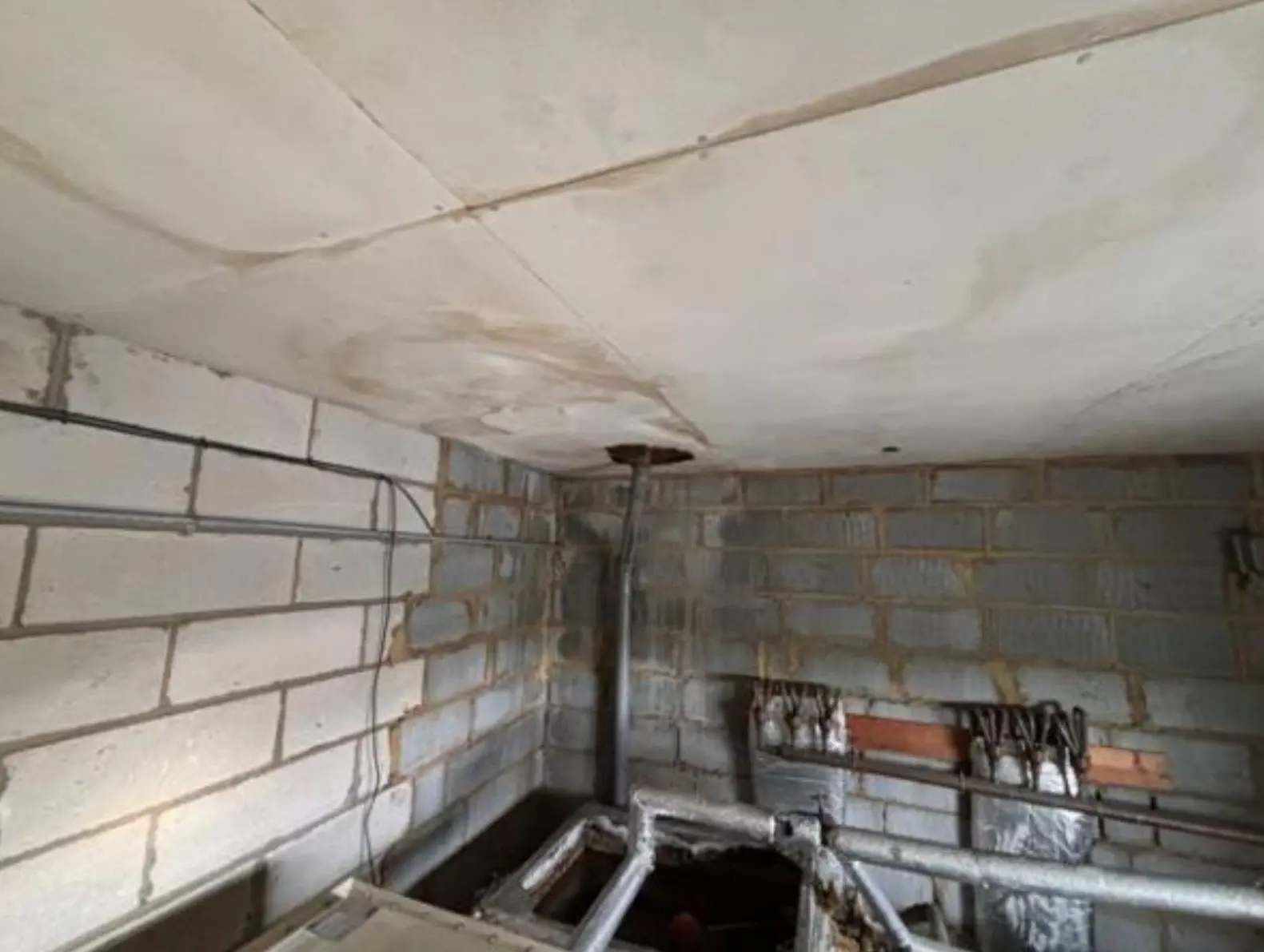 Ceiling panels in a property before asbestos insulating board removal