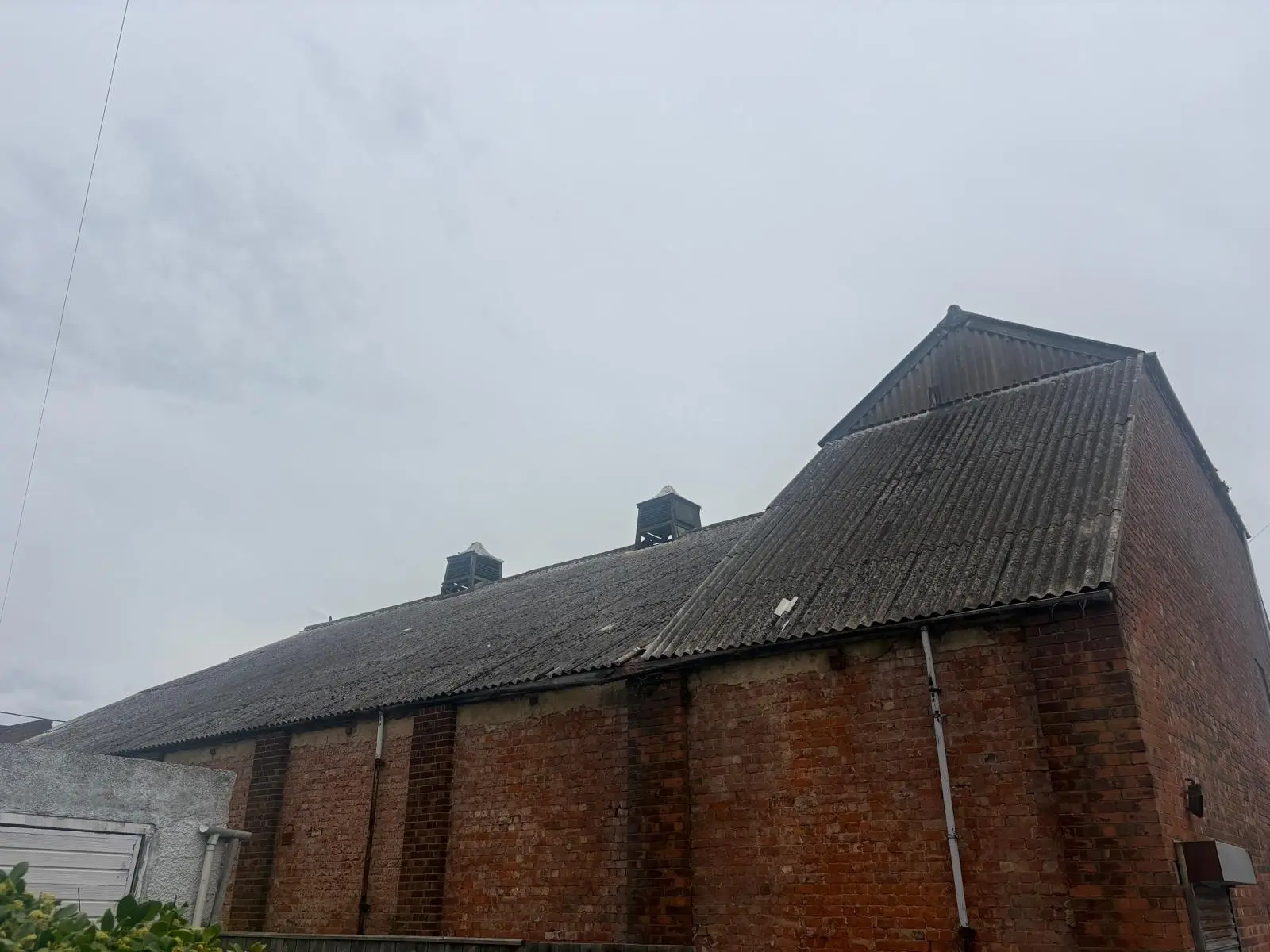 Asbestos roof removal Croydon borough - Croydon Library CR0 Asbestos roof removal Croydon borough - Croydon Library CR0; large pitched corrugated roof above a brick building